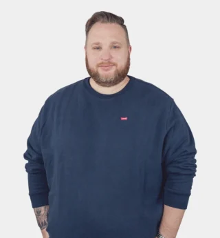 A Man With A Beard And Mustache Wearing A Blue Sweater