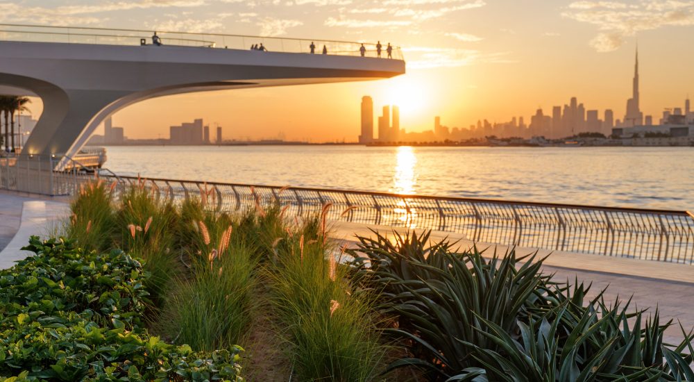 Stunning sunset view of Downtown Dubai skyline from Dubai Creek Harbour, UAE, capturing the beauty of modern urban landscapes and travel destinations